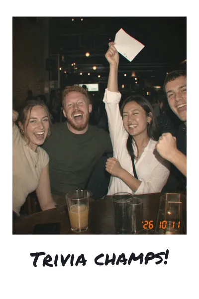 A print of four friends celebrating, captioned Trivia champs